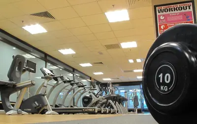 a gym with rows of dumbbells in a gym at Micasa All Suites Hotel in Kuala Lumpur