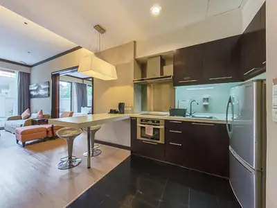a kitchen with a table and a counter top at Micasa All Suites Hotel in Kuala Lumpur