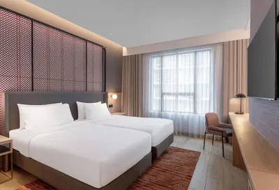 a hotel room with a large bed and a desk at Grand Mercure Kuala Lumpur Bukit Bintang in Kuala Lumpur