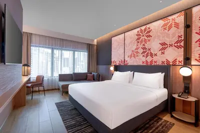 a hotel room with a bed and a couch at Grand Mercure Kuala Lumpur Bukit Bintang in Kuala Lumpur