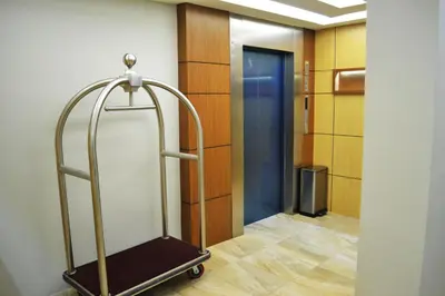 a hallway with a luggage cart in a room at City Central Hotel in Kuala Lumpur