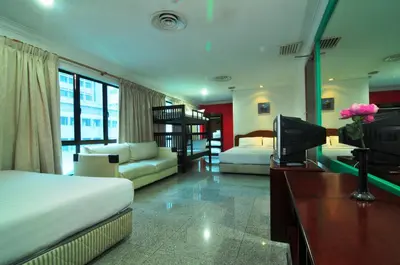 a hotel room with two beds and a television at Hotel China Town 2 in Kuala Lumpur