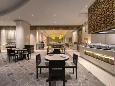 a restaurant with tables and chairs and a buffet at Novotel Kuala Lumpur City Centre in Kuala Lumpur