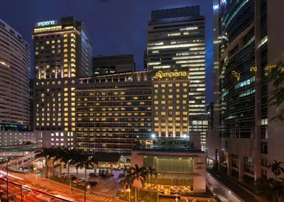 a view of a city at night with tall buildings at Impiana KLCC Hotel in Kuala Lumpur