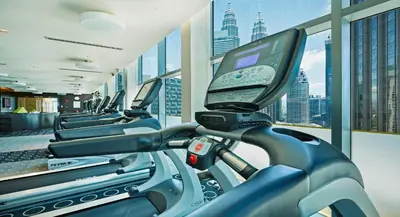 a row of treadmills in a gym at Impiana KLCC Hotel in Kuala Lumpur