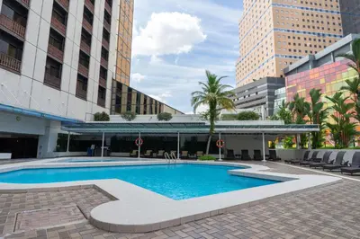 a swimming pool in the middle of a building at Seri Pacific Hotel Kuala Lumpur in Kuala Lumpur