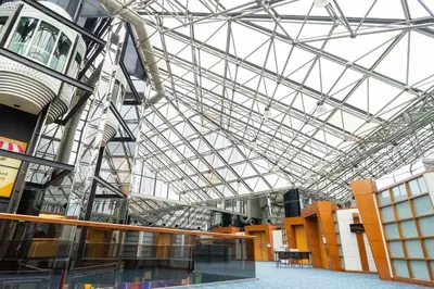 a large glass ceiling in a building with a table at Seri Pacific Hotel Kuala Lumpur in Kuala Lumpur