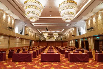 a large banquet hall with brown tables and chandeliers at Seri Pacific Hotel Kuala Lumpur in Kuala Lumpur