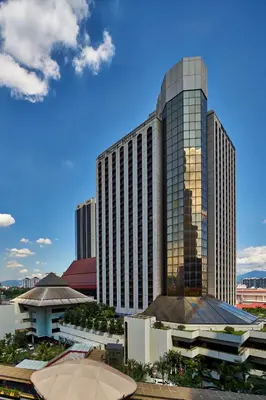 a tall building with a reflection of the city at Seri Pacific Hotel Kuala Lumpur in Kuala Lumpur
