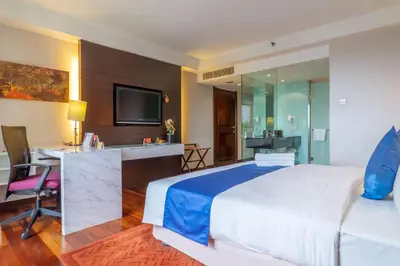 a hotel room with a large bed and a desk at Seri Pacific Hotel Kuala Lumpur in Kuala Lumpur