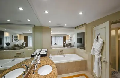 a bathroom with two sinks and a bath tub at InterContinental Kuala Lumpur by IHG in Kuala Lumpur