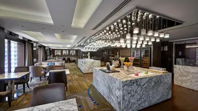 a hotel lobby with a bar and a restaurant at InterContinental Kuala Lumpur by IHG in Kuala Lumpur