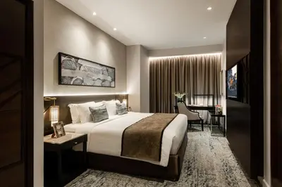 a hotel room with a bed and a desk at Ascott Kuala Lumpur in Kuala Lumpur