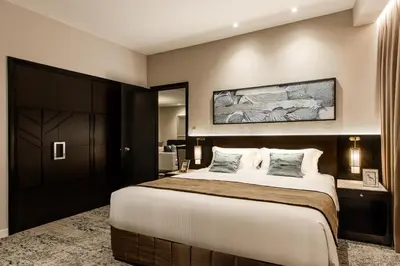 a bedroom with a large bed in a room at Ascott Kuala Lumpur in Kuala Lumpur