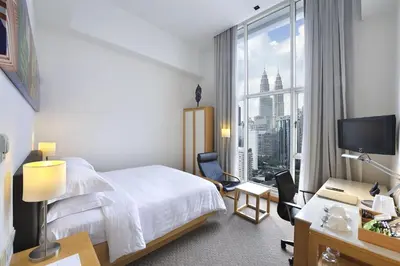 a hotel room with a bed and a large window at Hotel Capitol Kuala Lumpur in Kuala Lumpur