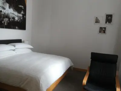 a bedroom with a bed and a chair at Hotel Capitol Kuala Lumpur in Kuala Lumpur