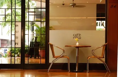 a table and two chairs in front of a window at Hotel Capitol Kuala Lumpur in Kuala Lumpur