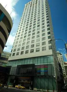 a tall white building with a car in front of it at Hotel Capitol Kuala Lumpur in Kuala Lumpur