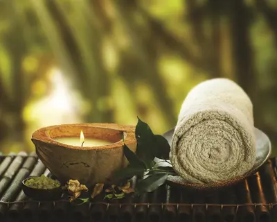 a candle and a towel on a table at Berjaya Times Square Hotel, Kuala Lumpur in Kuala Lumpur
