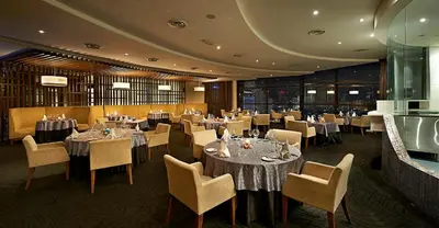 a dining room with tables and chairs and tablesearcher at Berjaya Times Square Hotel, Kuala Lumpur in Kuala Lumpur