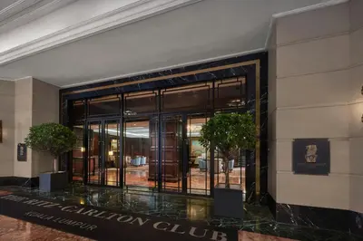 a lobby of a building with two potted plants at The Ritz-Carlton, Kuala Lumpur in Kuala Lumpur