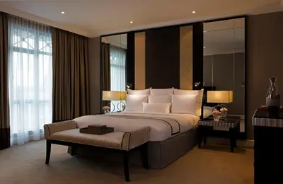 a bedroom with a large bed and a large window at The Ritz-Carlton, Kuala Lumpur in Kuala Lumpur