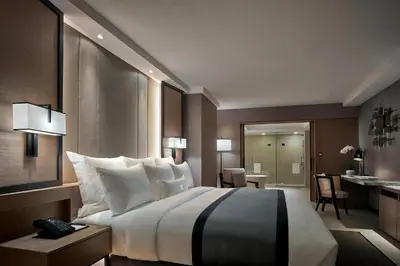 a hotel room with a large bed and a bathroom at JW Marriott Kuala Lumpur in Kuala Lumpur