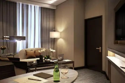 a living room with a couch and a table with wine glasses at JW Marriott Kuala Lumpur in Kuala Lumpur