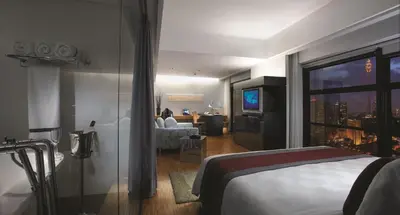 a hotel room with a bed and a living room at Hotel Maya Kuala Lumpur City Centre in Kuala Lumpur