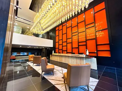 a lobby with chairs and a bar in a building at Starus Hotel Bukit Bintang in Kuala Lumpur