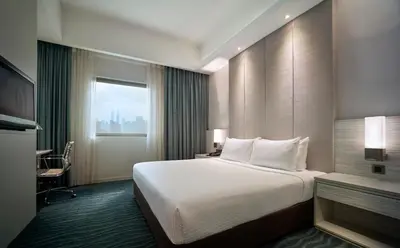 a hotel room with a large bed and a window at Sunway Putra Hotel Kuala Lumpur in Kuala Lumpur