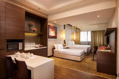 a hotel room with a bed and a dining room at Sunway Putra Hotel Kuala Lumpur in Kuala Lumpur