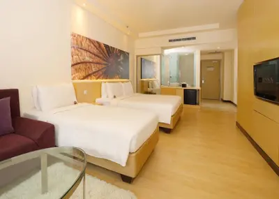 a hotel room with two beds and a tv at ANSA Hotel Kuala Lumpur in Kuala Lumpur