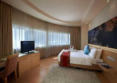 a bedroom with a bed and a flat screen tv at ANSA Hotel Kuala Lumpur in Kuala Lumpur