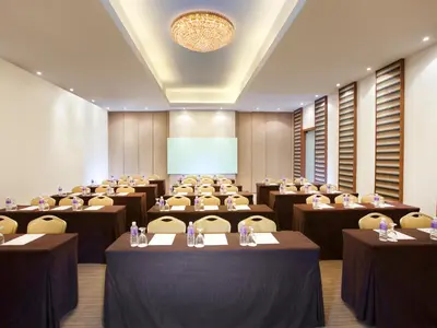 a conference room with tables and chairs and a chandelier at Silka Maytower Kuala Lumpur in Kuala Lumpur