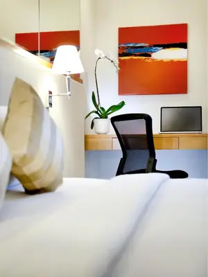 a bedroom with a bed with a desk and a chair at Silka Maytower Kuala Lumpur in Kuala Lumpur