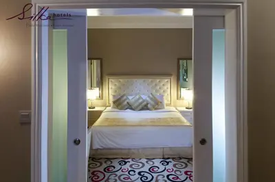 a bedroom with a bed with a white bedspread at Silka Maytower Kuala Lumpur in Kuala Lumpur