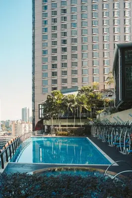 a large swimming pool in front of a tall building at St Giles Mid Valley Kuala Lumpur in Kuala Lumpur