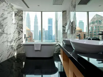 a bathroom with two sinks and a large window at Pullman Kuala Lumpur City Centre Hotel & Residences in Kuala Lumpur