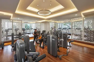 a gym with treadmills and elliptical machines at Mandarin Oriental, Kuala Lumpur in Kuala Lumpur
