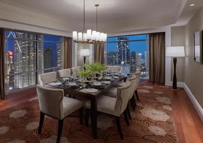 a dining room with a table and chairs and a large window at Mandarin Oriental, Kuala Lumpur in Kuala Lumpur