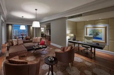 a living room with a couch and a table at Mandarin Oriental, Kuala Lumpur in Kuala Lumpur