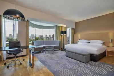 a hotel room with a bed and a desk and chair at Renaissance Kuala Lumpur Hotel & Convention Centre in Kuala Lumpur