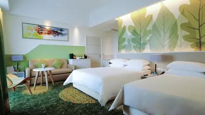 a hotel room with two beds and a couch at Sunway Velocity Hotel Kuala Lumpur in Kuala Lumpur