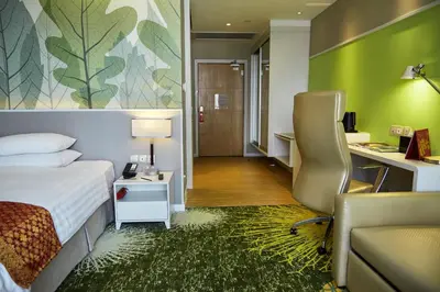 a hotel room with a bed and a desk at Sunway Velocity Hotel Kuala Lumpur in Kuala Lumpur