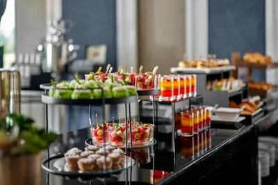 a buffet of food with fruit and drinks on display at AC Hotel by Marriott Kuala Lumpur in Kuala Lumpur