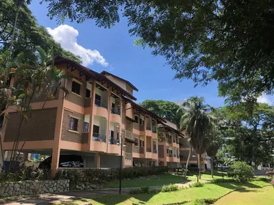 a building with a palm tree in front of it at Flamingo Hotel By The Lake, Kuala Lumpur in Kuala Lumpur