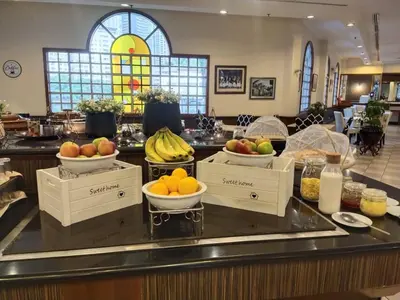 a buffet with bowls of fruit on a counter at Flamingo Hotel By The Lake, Kuala Lumpur in Kuala Lumpur