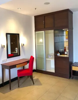 a room with a desk and a red chair at Flamingo Hotel By The Lake, Kuala Lumpur in Kuala Lumpur