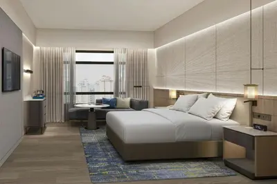 a hotel room with a bed and a couch at Petaling Jaya Marriott Hotel in Petaling Jaya
